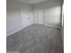 Well-lit bedroom, gray tile floor, and closet at 38422 W Buckeye Rd, Tonopah, AZ 85354
