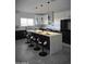 Modern kitchen with large island, black cabinets, and quartz countertop at 38422 W Buckeye Rd, Tonopah, AZ 85354