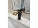 Modern black and gold bathroom faucet on marble countertop at 38422 W Buckeye Rd, Tonopah, AZ 85354