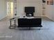 Spacious living room with gray tile floors and built-in shelving at 38422 W Buckeye Rd, Tonopah, AZ 85354