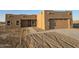 Newly constructed home with stucco exterior, attached garage, and walkway at 38422 W Buckeye Rd, Tonopah, AZ 85354