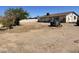 Large backyard with a mostly dirt yard and a trailer at 1618 N 52Nd Dr, Phoenix, AZ 85035