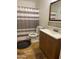 Clean bathroom with a shower/tub combo and wood vanity at 1618 N 52Nd Dr, Phoenix, AZ 85035