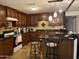 L-shaped kitchen with island and dark wood cabinets at 1618 N 52Nd Dr, Phoenix, AZ 85035