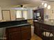 Open kitchen with a breakfast bar and dark wood cabinets at 1618 N 52Nd Dr, Phoenix, AZ 85035