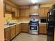 Modern kitchen featuring stainless steel appliances and wood cabinets at 1129 E Love St, Casa Grande, AZ 85122