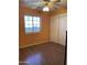 Spacious bedroom with wood flooring, ceiling fan, and double-door closet at 1129 E Love St, Casa Grande, AZ 85122