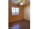 Spacious bedroom with wood flooring, ceiling fan, and double-door closet at 1129 E Love St, Casa Grande, AZ 85122