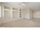 Spacious living room with built-in shelving and carpet at 19051 N Aztec Point Dr, Surprise, AZ 85387