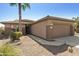 Single story home with attached garage and desert landscaping at 19051 N Aztec Point Dr, Surprise, AZ 85387