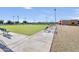 Outdoor bocce ball court with benches and a nearby building at 19051 N Aztec Point Dr, Surprise, AZ 85387