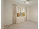 Well-lit bedroom with window and neutral carpeting at 19051 N Aztec Point Dr, Surprise, AZ 85387