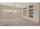 Living room featuring built-in shelving and carpet at 19051 N Aztec Point Dr, Surprise, AZ 85387