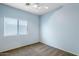 Light blue bedroom with ceiling fan, window blinds, and carpet flooring at 4536 W Rolling Rock Dr, Phoenix, AZ 85086