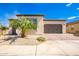 Modern home exterior with a two-car garage and desert landscaping at 36169 N Serrano Ave, Queen Creek, AZ 85140