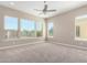 Spacious bedroom with large windows and ceiling fan at 36169 N Serrano Ave, Queen Creek, AZ 85140