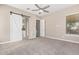 Primary bedroom with sliding barn door and ceiling fan at 36169 N Serrano Ave, Queen Creek, AZ 85140