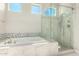 Spa-like bathroom with a soaking tub and a glass-enclosed shower at 36169 N Serrano Ave, Queen Creek, AZ 85140