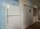 White refrigerator and sliding doors to laundry area at 8700 E University Dr # 1322, Mesa, AZ 85207