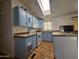 Kitchen with light blue cabinets and skylight at 8700 E University Dr # 1322, Mesa, AZ 85207
