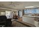 Open concept kitchen and living room with island and seating at 8700 E University Dr # 1322, Mesa, AZ 85207