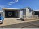 Mobile home with carport, covered patio, and gated yard at 8700 E University Dr # 1322, Mesa, AZ 85207