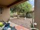 Relaxing backyard oasis with mature tree and stone accents at 148 S 225Th Ln, Buckeye, AZ 85326