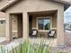 Front porch with seating area and landscaping at 148 S 225Th Ln, Buckeye, AZ 85326