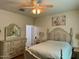Bright bedroom with a queen-size bed and ample dresser storage at 148 S 225Th Ln, Buckeye, AZ 85326