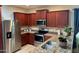 Modern kitchen with granite countertops and stainless steel appliances at 148 S 225Th Ln, Buckeye, AZ 85326