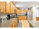 Open concept kitchen with wood cabinets and granite counters at 35202 N 30Th Dr, Phoenix, AZ 85086