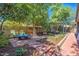 Landscaped backyard with pergola, patio furniture and brick walkways at 35202 N 30Th Dr, Phoenix, AZ 85086