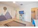 Bedroom with mountain mural, TV, and built-in shelving at 35202 N 30Th Dr, Phoenix, AZ 85086