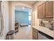 Wet bar with wood cabinets, a coffee maker, and a mini fridge at 35202 N 30Th Dr, Phoenix, AZ 85086