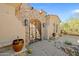 Elegant front entrance with stonework, iron gate, and landscaped walkway at 36530 N Boulder View Dr, Scottsdale, AZ 85262