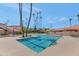 Inviting community pool with surrounding lounge chairs and palm trees at 17404 N 99Th Ave # 108, Sun City, AZ 85373