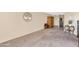 Spacious living room with carpet and access to other rooms at 17404 N 99Th Ave # 108, Sun City, AZ 85373