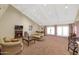 Spacious clubhouse with comfortable seating, fireplace, and large windows at 17404 N 99Th Ave # 108, Sun City, AZ 85373