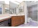 Main bathroom with double vanity and shower/tub at 17404 N 99Th Ave # 108, Sun City, AZ 85373