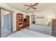 Bedroom with twin beds, built-in shelves, and bathroom view at 17404 N 99Th Ave # 108, Sun City, AZ 85373