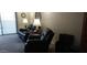 Living room with reclining sofas and ample natural light at 17404 N 99Th Ave # 108, Sun City, AZ 85373