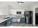 Modern kitchen with blue cabinets and stainless steel appliances at 16275 W Buchanan St, Goodyear, AZ 85338