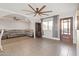 Living room features hardwood floors, a neutral sofa, and an arched doorway at 323 N 69Th Ave, Phoenix, AZ 85043