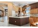 Modern kitchen with a large island, ample counter space, and light wood cabinets at 19973 N Half Moon Dr, Surprise, AZ 85374