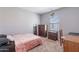 Bright bedroom with double bed, dresser, and workspace at 29405 N 123Rd Gln, Peoria, AZ 85383
