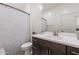 Clean bathroom with dark vanity, white countertop, and floral shower curtain at 29405 N 123Rd Gln, Peoria, AZ 85383
