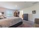Main bedroom with large bed and ensuite bathroom access at 29405 N 123Rd Gln, Peoria, AZ 85383