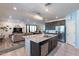 Open kitchen boasts a large island, granite countertops, and views into the living room at 29405 N 123Rd Gln, Peoria, AZ 85383