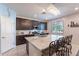 Island kitchen with granite countertops, stainless steel appliances, and breakfast bar seating at 29405 N 123Rd Gln, Peoria, AZ 85383