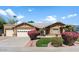 Beautiful tan home with a two-car garage and lush landscaping at 8894 E Sheena Dr, Scottsdale, AZ 85260